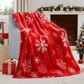 Soft red American style flannel Christmas blanket draped over a sofa