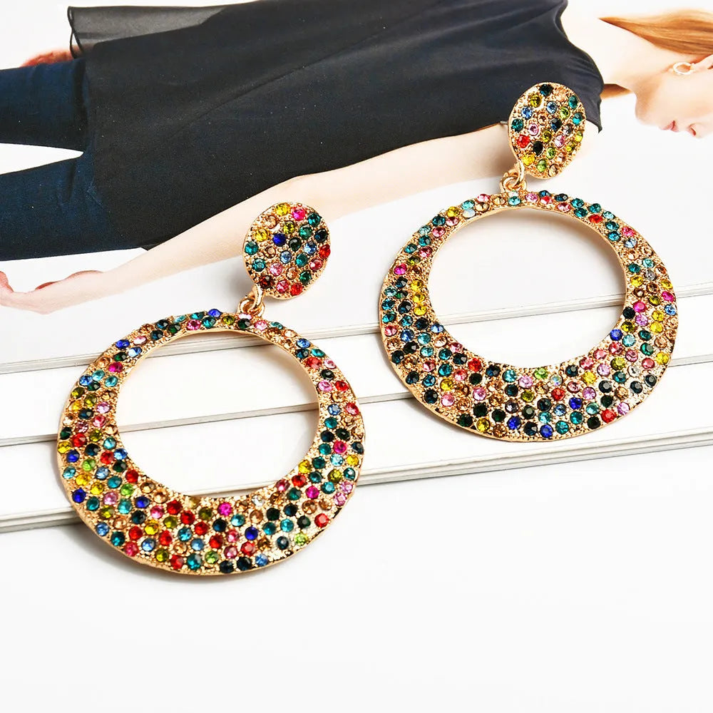 A pair of large round colour alloy pendant earrings with a cartoon style and diamond details for women.