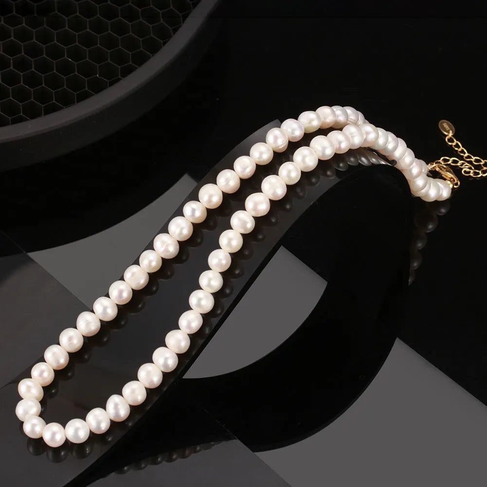 Silver adjustable necklace with freshwater pearl pendant on display