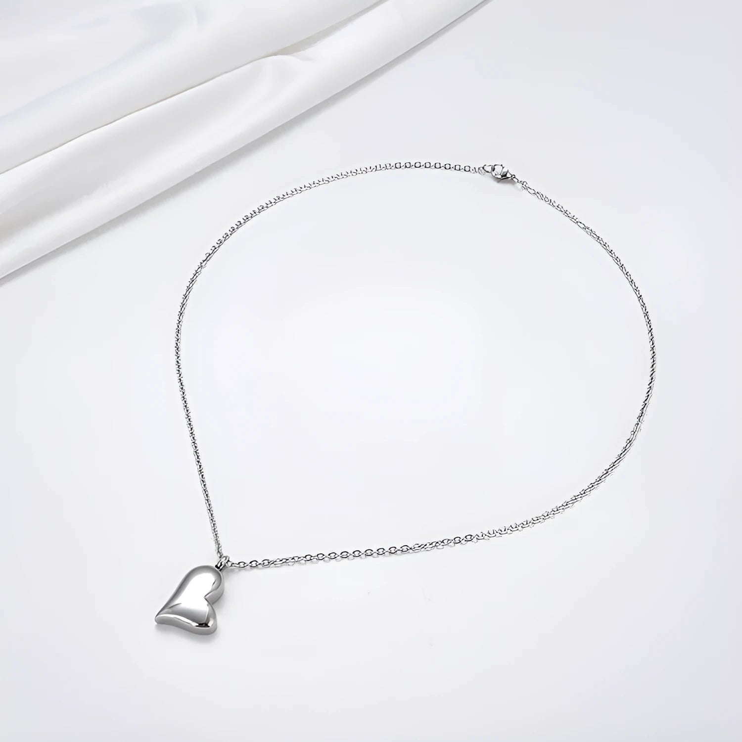Silver curved peach heart stainless steel pendant necklace with adjustable chain length