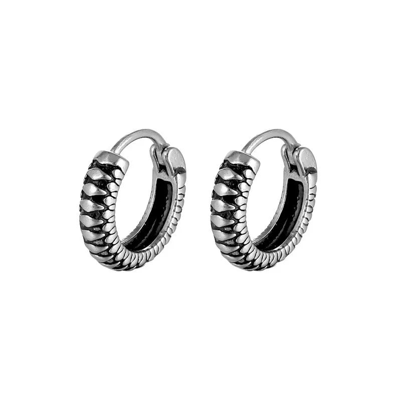 Silver geometric twist earrings with circular elements on white background