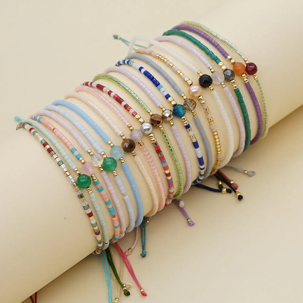 Handmade women's beaded bracelet with colourful glass and glaze beads in geometric bohemian style