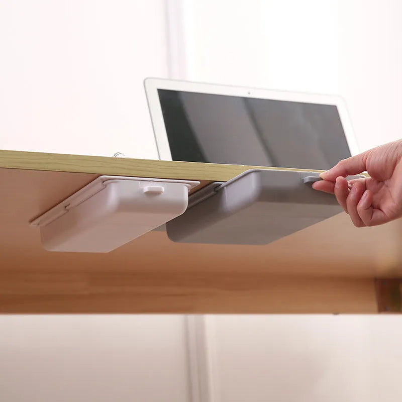 Adhesive under-table plastic storage drawer with covered design and grid pattern organisation in solid colours