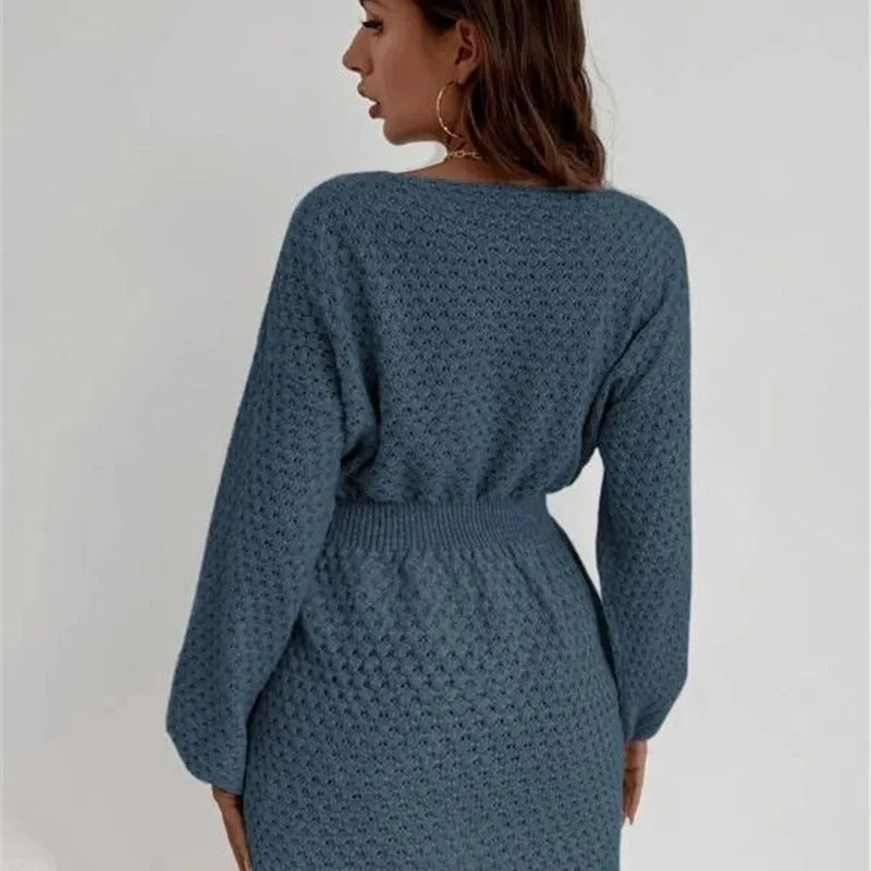 Blue women's knitted dress with hand-crocheted floral details on the front, showing fitted waist and round neck.