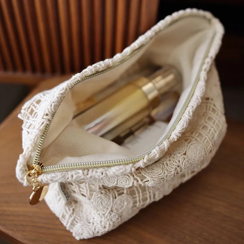 Handmade corduroy cosmetic bag with a crocheted hollow flower and ethnic embroidery design.