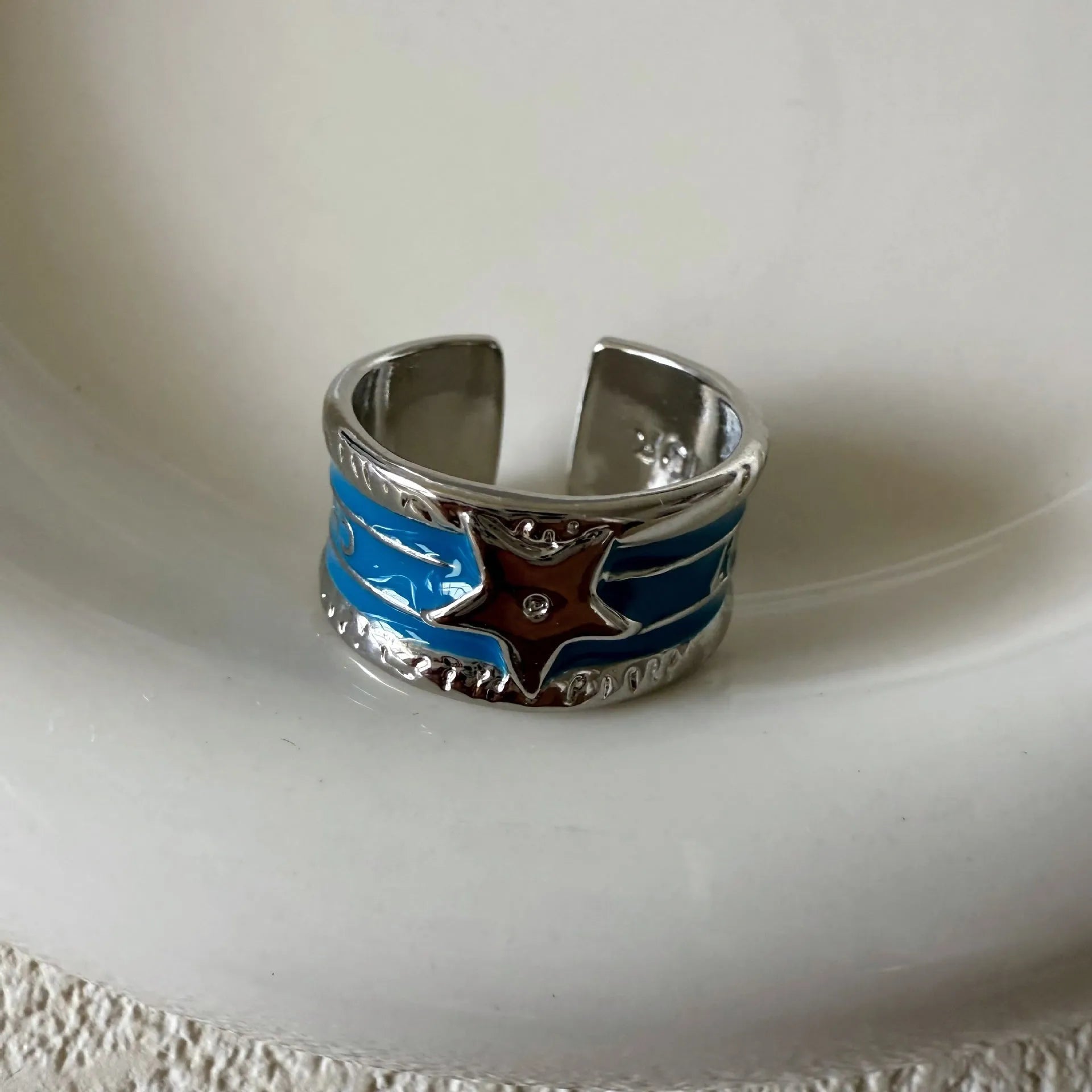 Adjustable copper geometry ring with distressed XINGX drop oil design in choice of colours.