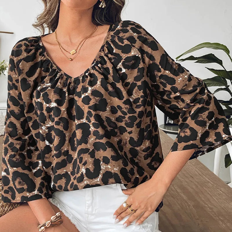 Women's multicolour leopard print V-neck pullover top with half sleeves and pleated detail.