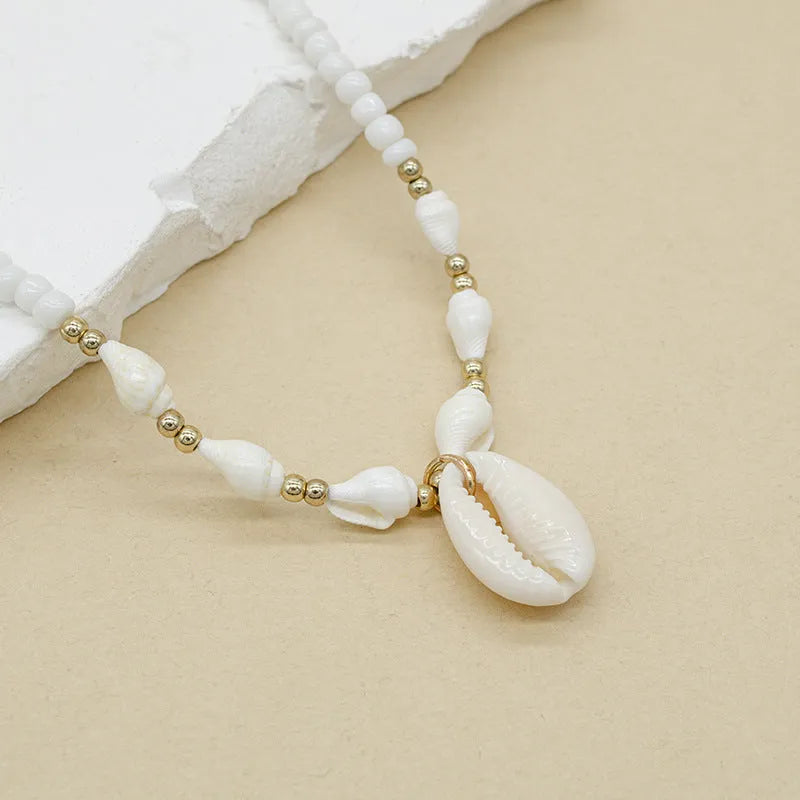 White conch shell bead necklace with mother pearl shellfish pendant on electroplated chain