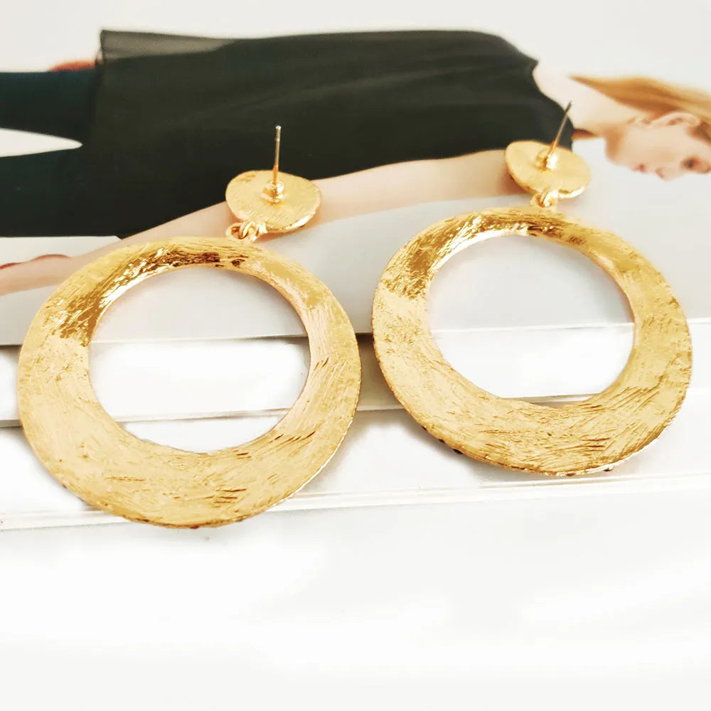 A pair of large round colour alloy pendant earrings with a cartoon style and diamond details for women.