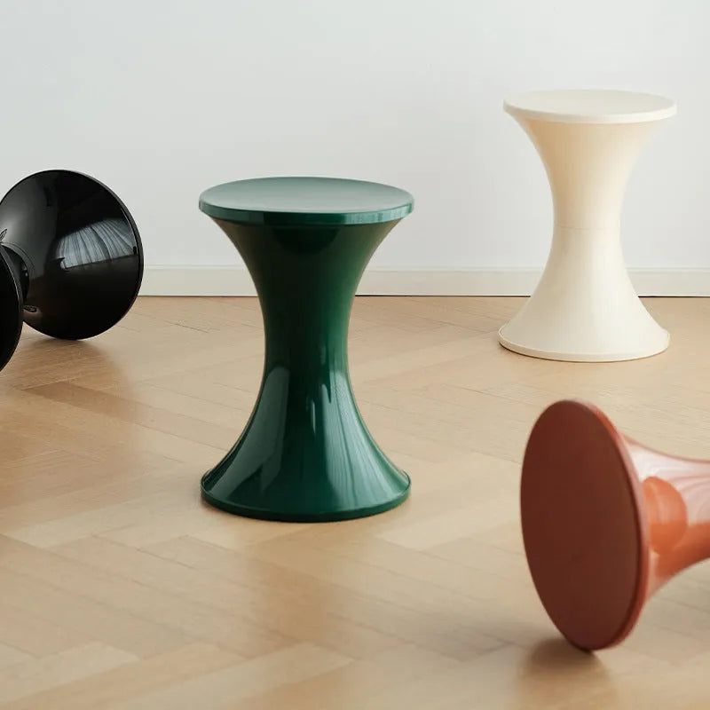 Hourglass-shaped plastic shoe changing stool in a choice of five colours: black, green, red, white, brown.