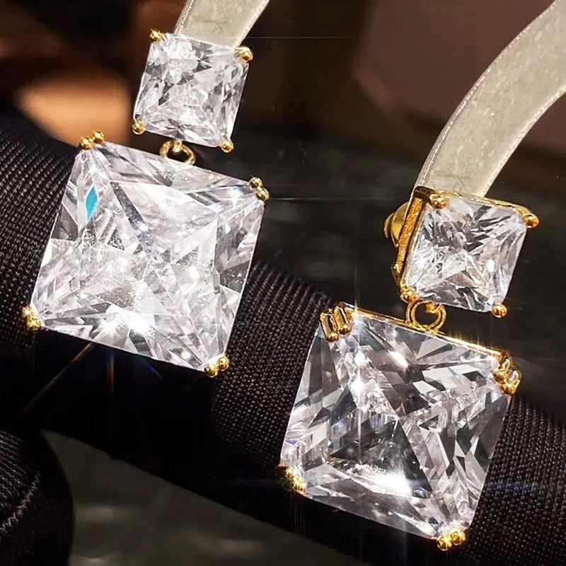 A pair of geometric square design copper earrings for women in gold and white gold colour options.
