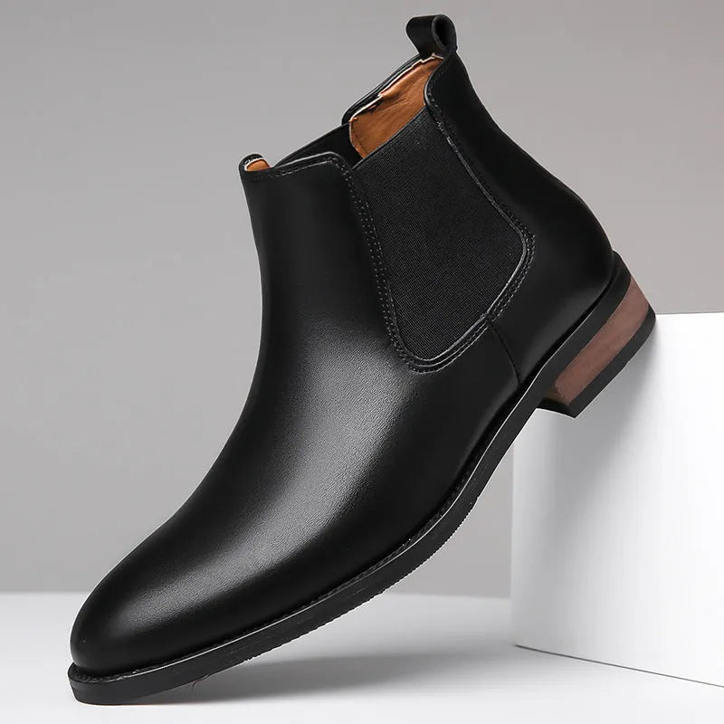 Men's black Chelsea boots with pointed toe design and artificial PU leather construction
