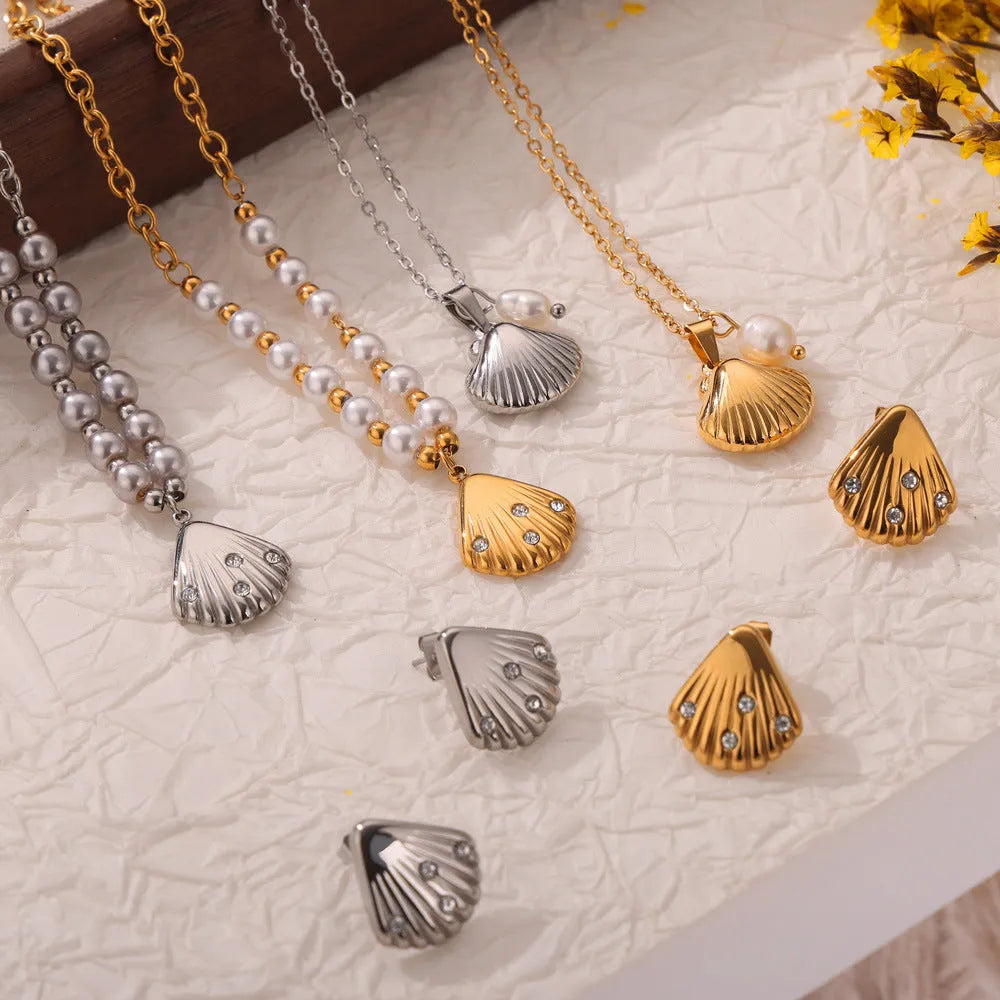 Gold-tone titanium steel necklace with white freshwater pearl beads on an O-shaped chain.
