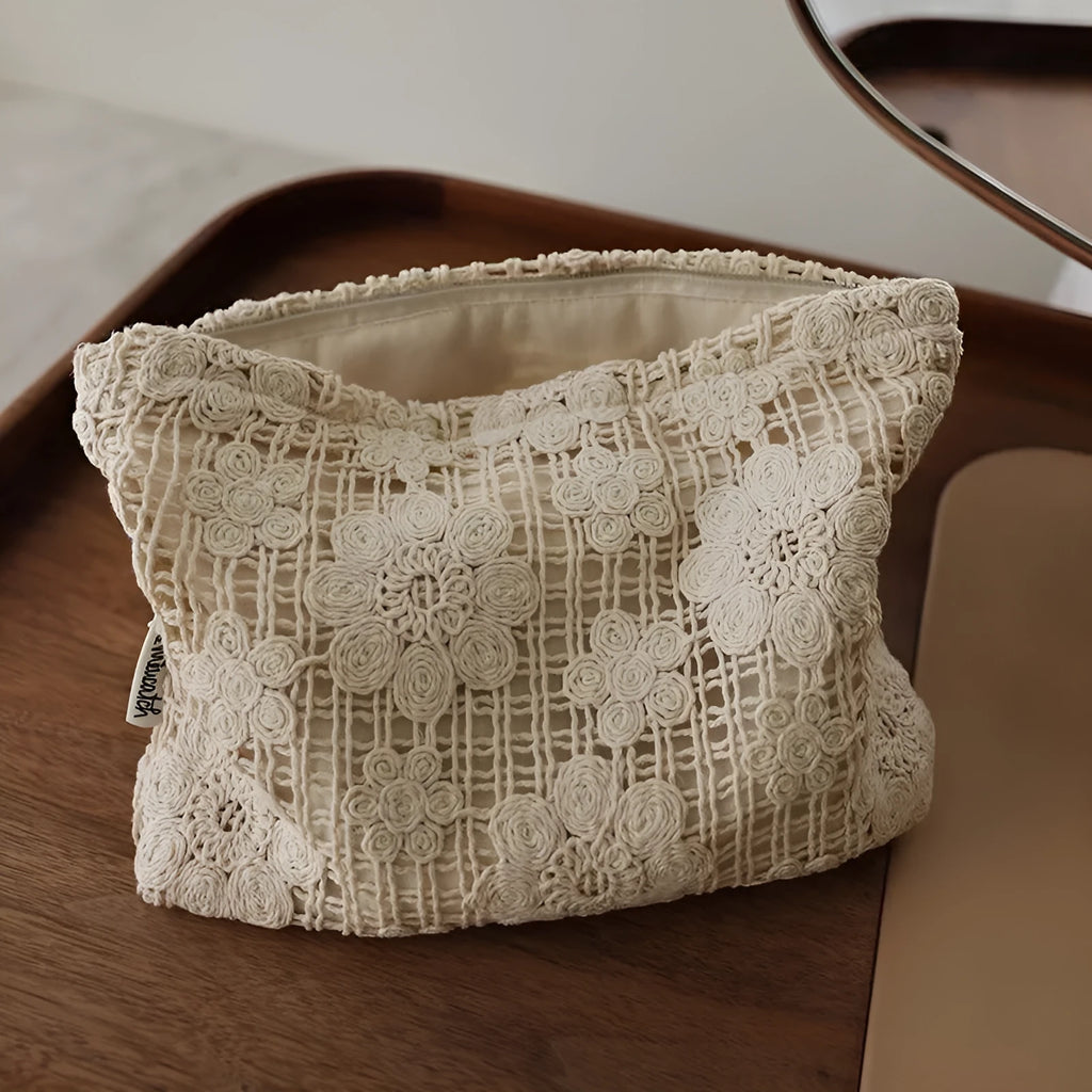 Handmade corduroy cosmetic bag with a crocheted hollow flower and ethnic embroidery design.