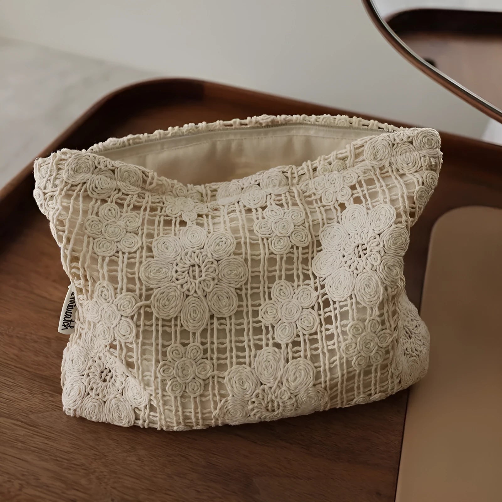 Handmade corduroy cosmetic bag with a crocheted hollow flower and ethnic embroidery design.