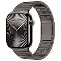 Stainless steel magnetic buckle watch strap for Apple Watch in silver colour on grey background