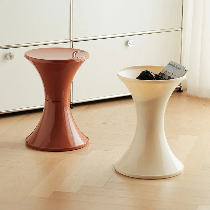 Hourglass-shaped plastic shoe changing stool in a choice of five colours: black, green, red, white, brown.