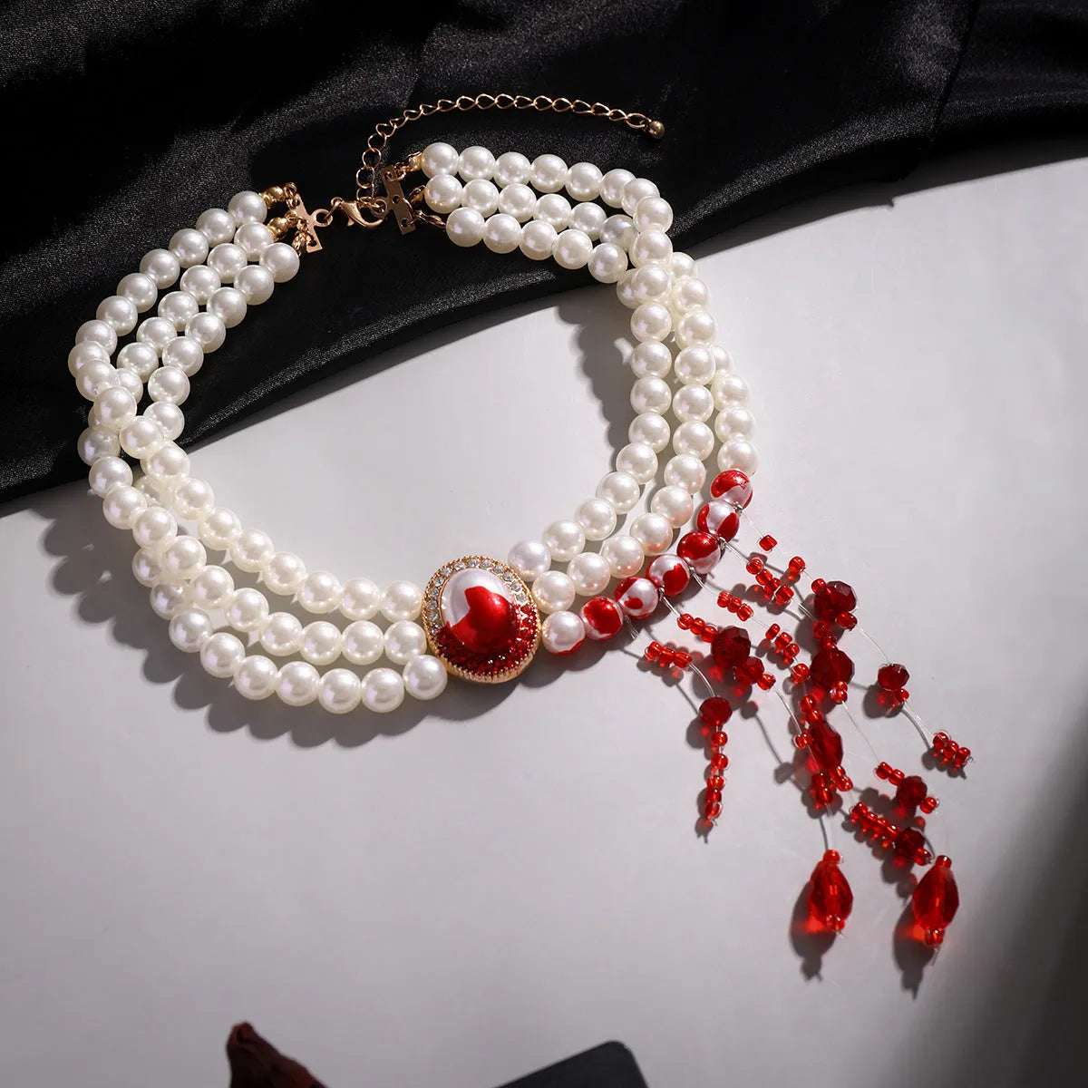 Gold Halloween pearl collar jewellery set with necklace, bracelet, and stud earrings on white background