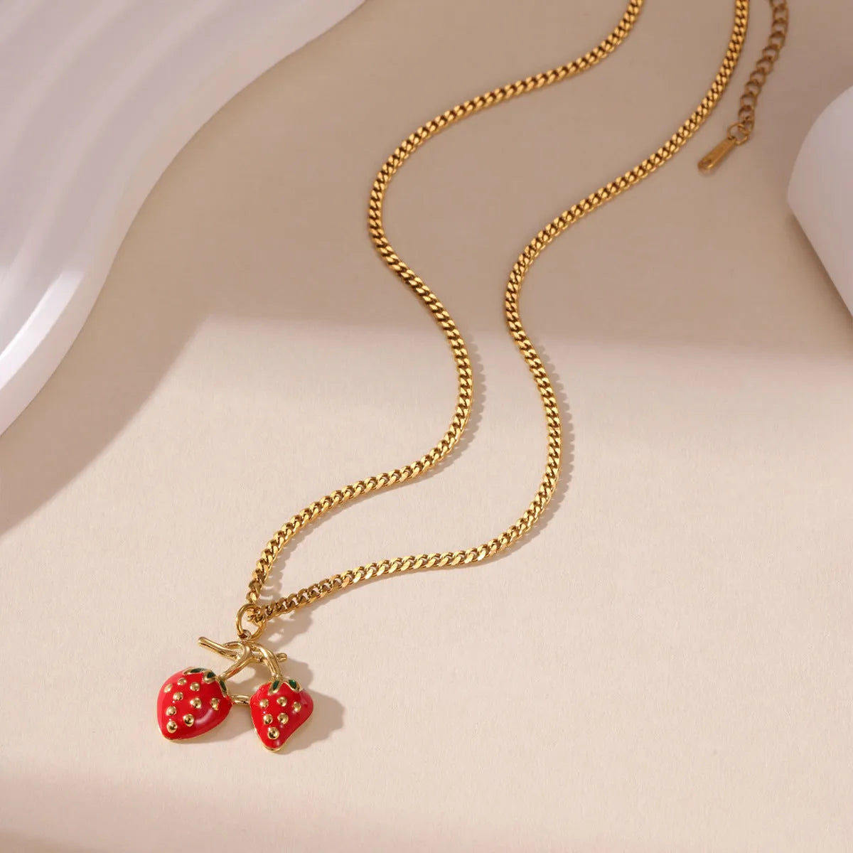 Stainless steel strawberry fruit pendant necklace in red and white gradient colour options.