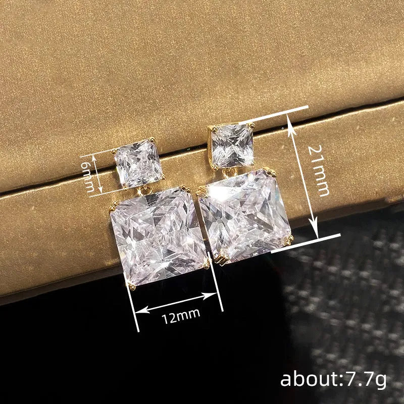 A pair of geometric square design copper earrings for women in gold and white gold colour options.