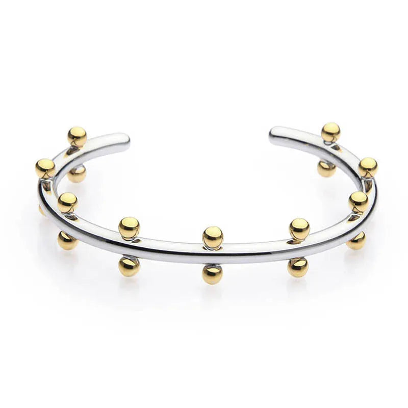 Stainless steel C-shaped bracelet with textured rivet bean beads in gold or steel colour.