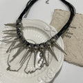 Women's leather necklace with electroplated rivets and a winding beaded tassel pendant