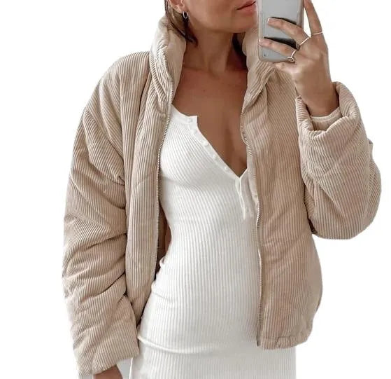 Women's apricot coloured corduroy jacket with a stand collar and front zipper on a hanger.
