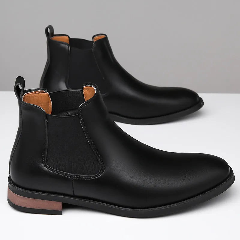 Men's black Chelsea boots with pointed toe design and artificial PU leather construction