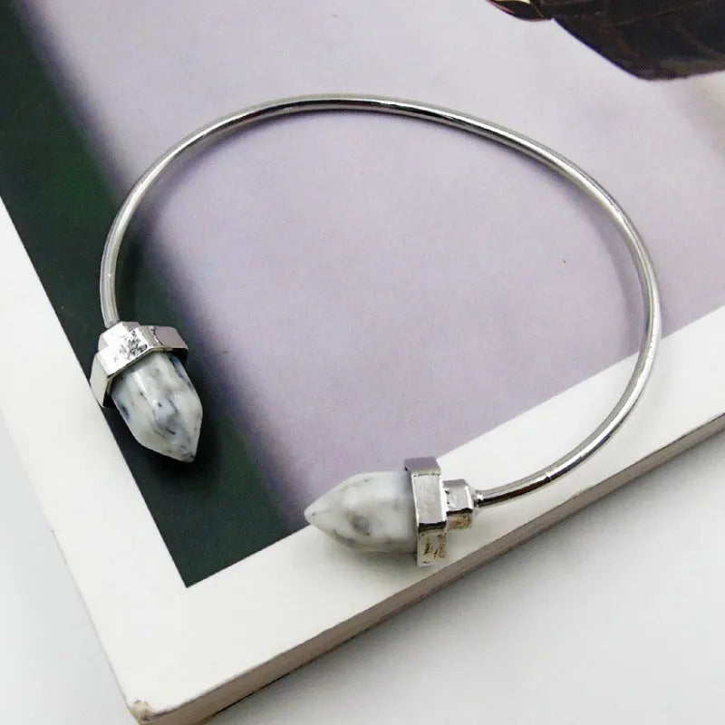 Natural alloy open-ended bracelet with inlaid gem turquoise style in silver blue finish on a neutral background
