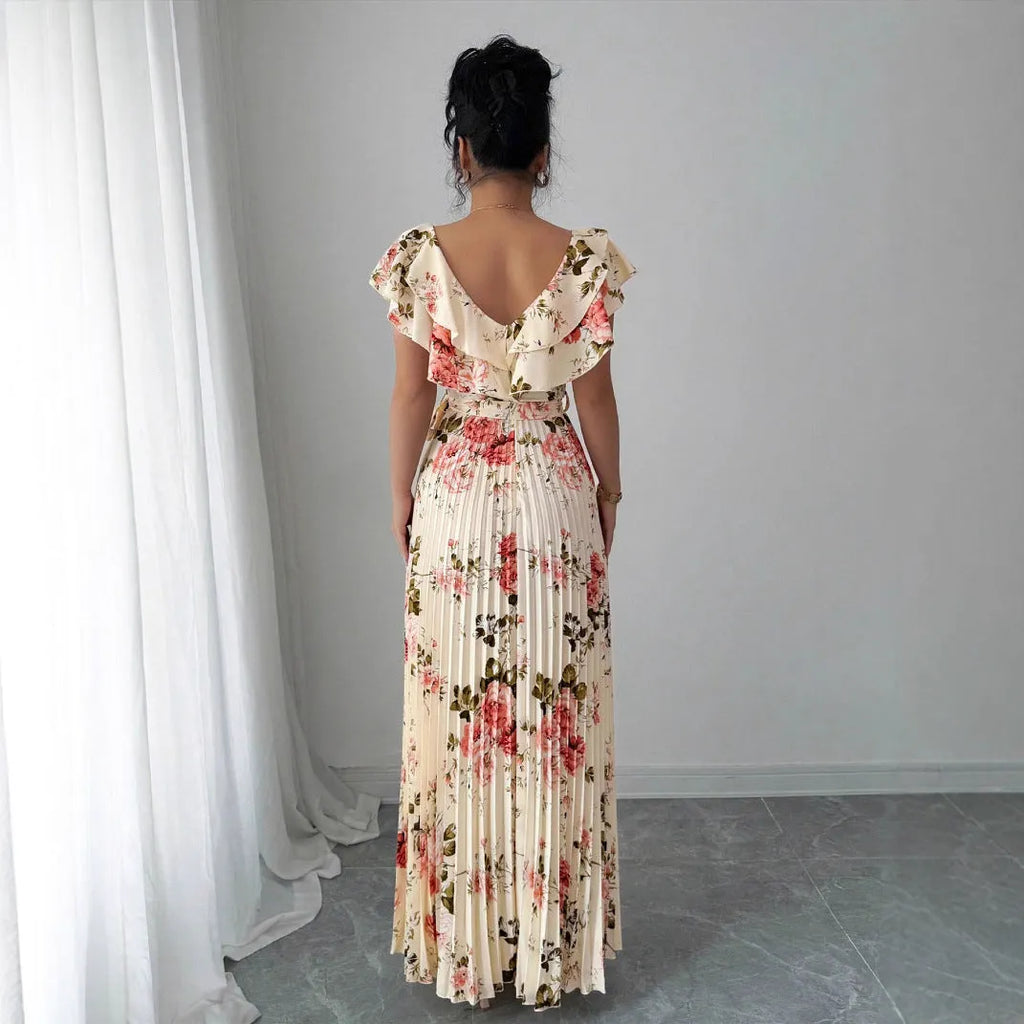 Apricot coloured floral print dress with a v-neck, ruffled short sleeves, and a long high-waisted swing skirt.
