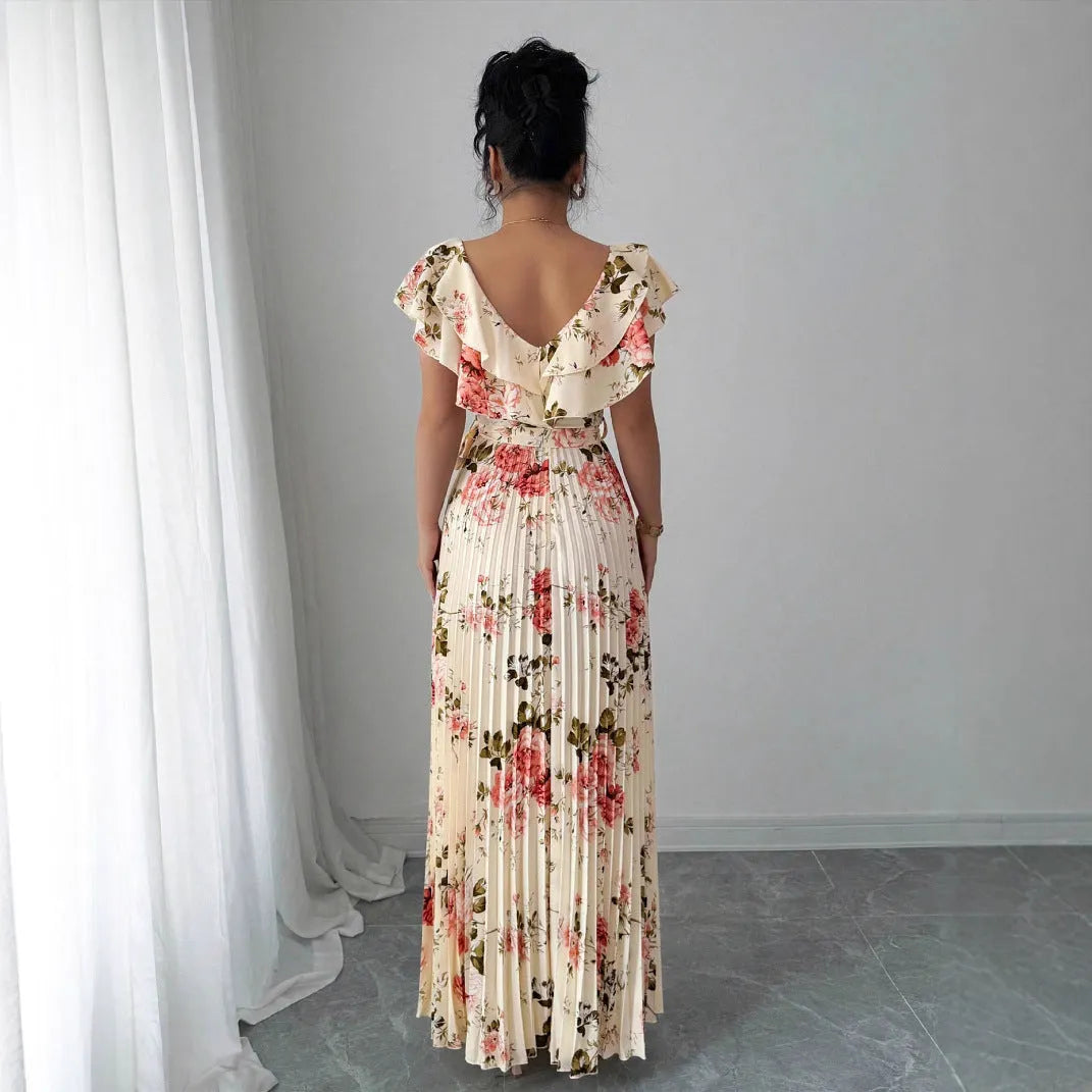 Apricot coloured floral print dress with a v-neck, ruffled short sleeves, and a long high-waisted swing skirt.