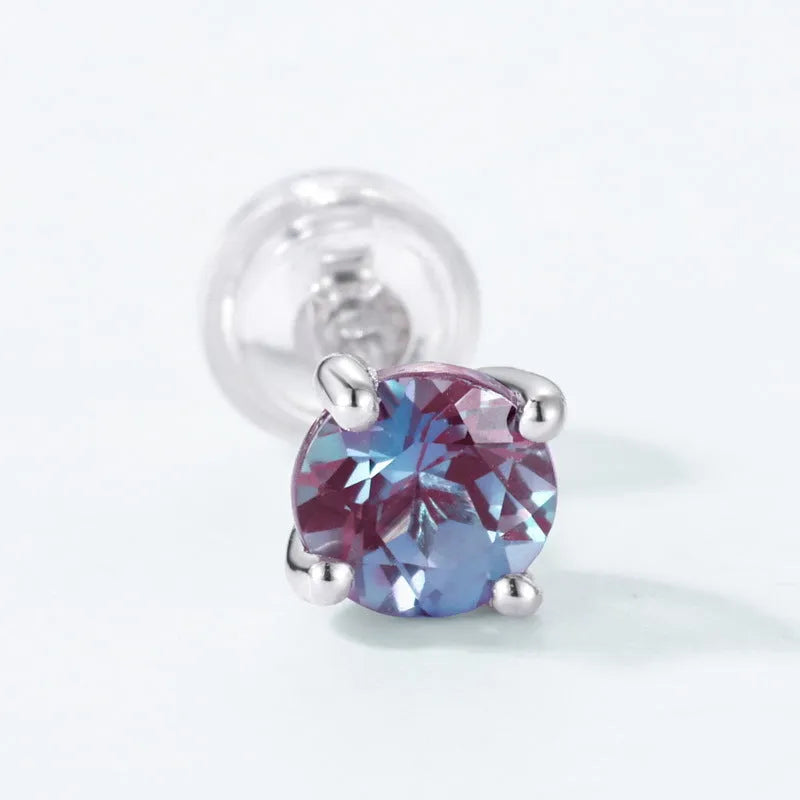 Simple geometric round ear studs in silver with a purple-green cultivate Alexandrite stone.