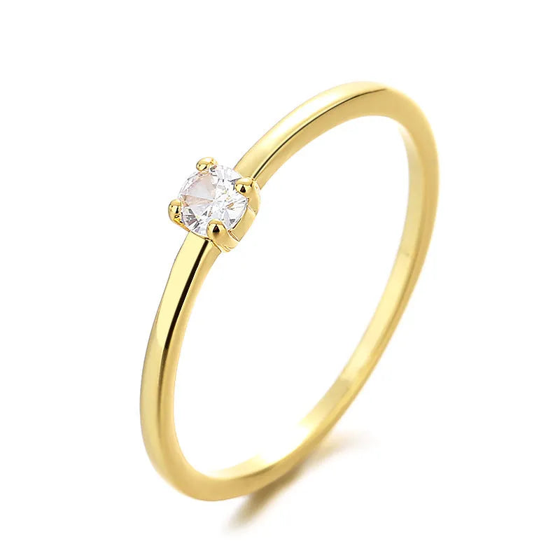 A women's fine copper circle ring with a single diamond, shown in blue, green, red, and white colour options.