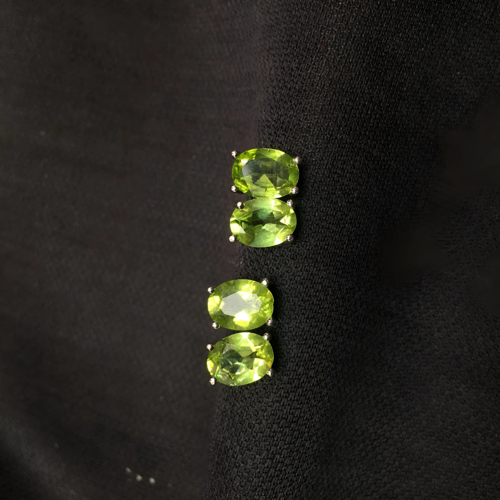 S925 silver stud earrings with a grass green natural olivine gemstone, elliptical cut.