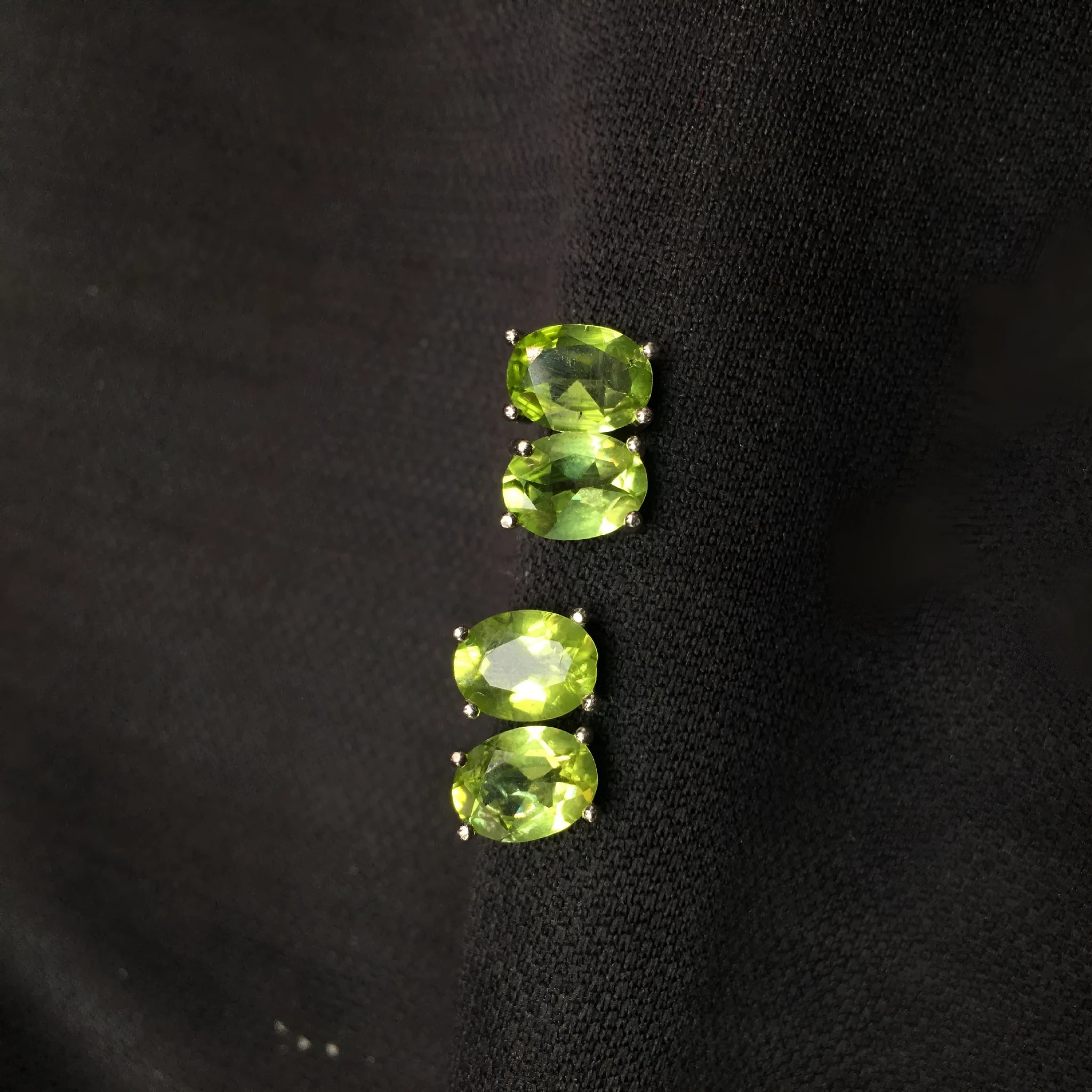 S925 silver stud earrings with a grass green natural olivine gemstone, elliptical cut.