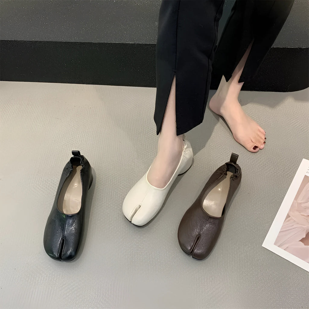 Women's brown split toe horseshoe design chunky heel pumps on a white background.