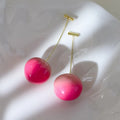 Handmade acrylic peach fruit earrings showing small and large size options with copper findings