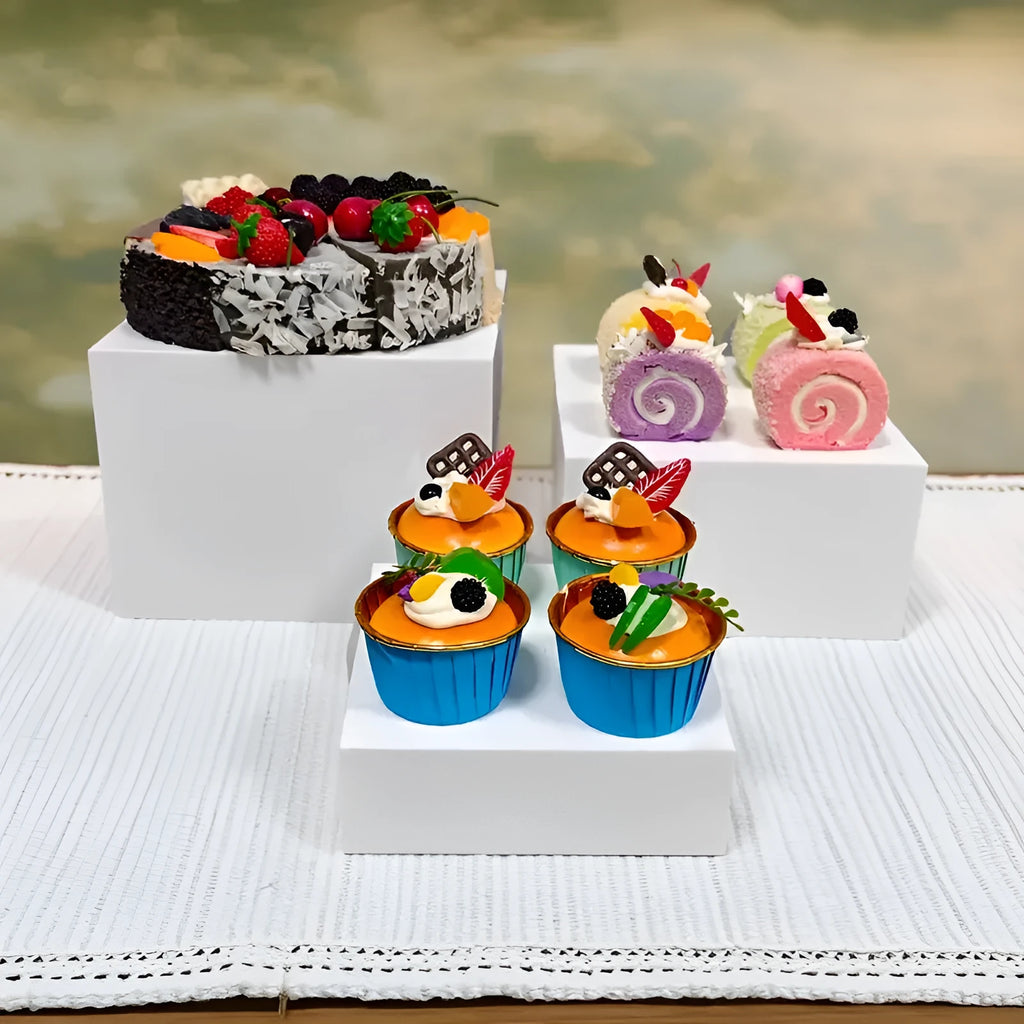 White plastic Suit Cube dessert display stand with six tiers showing cupcakes