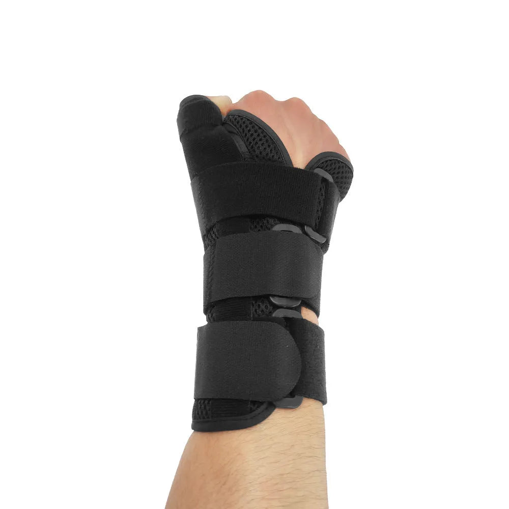 Black carbon fibre wrist guard with grey edging and a thumb strap, shown on a hand.