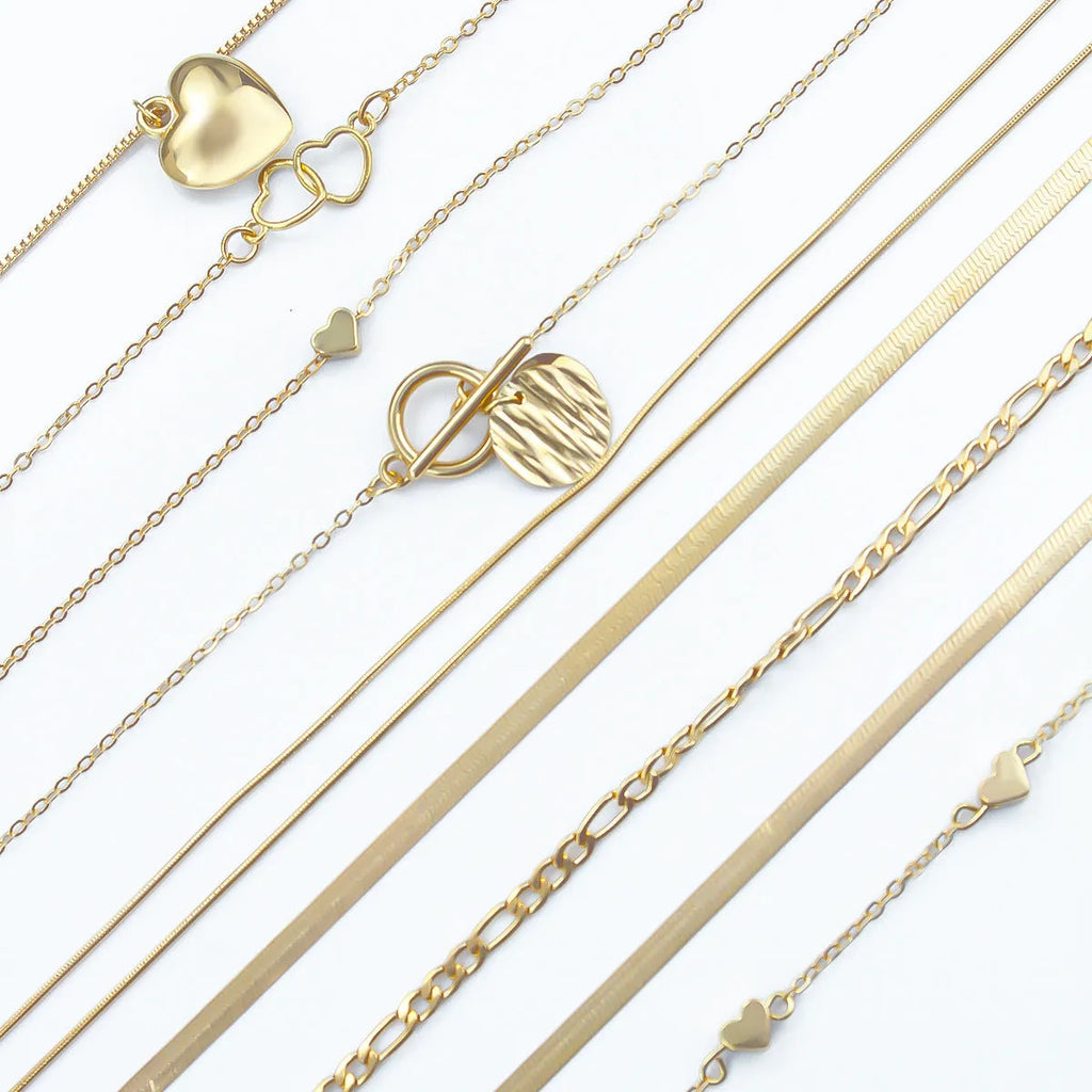 10 piece gold electroplated women's necklace set with adjustable chain length on display