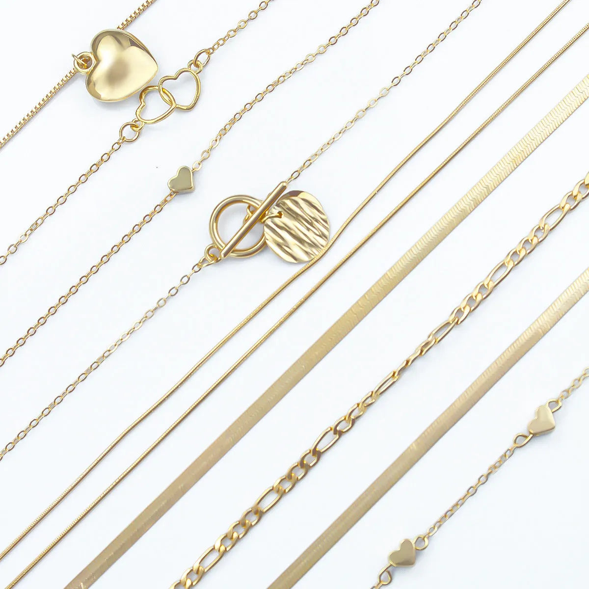 10 piece gold electroplated women's necklace set with adjustable chain length on display