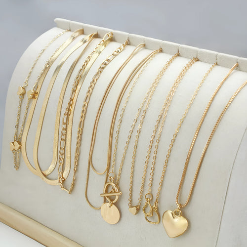 10 piece gold electroplated women's necklace set with adjustable chain length on display