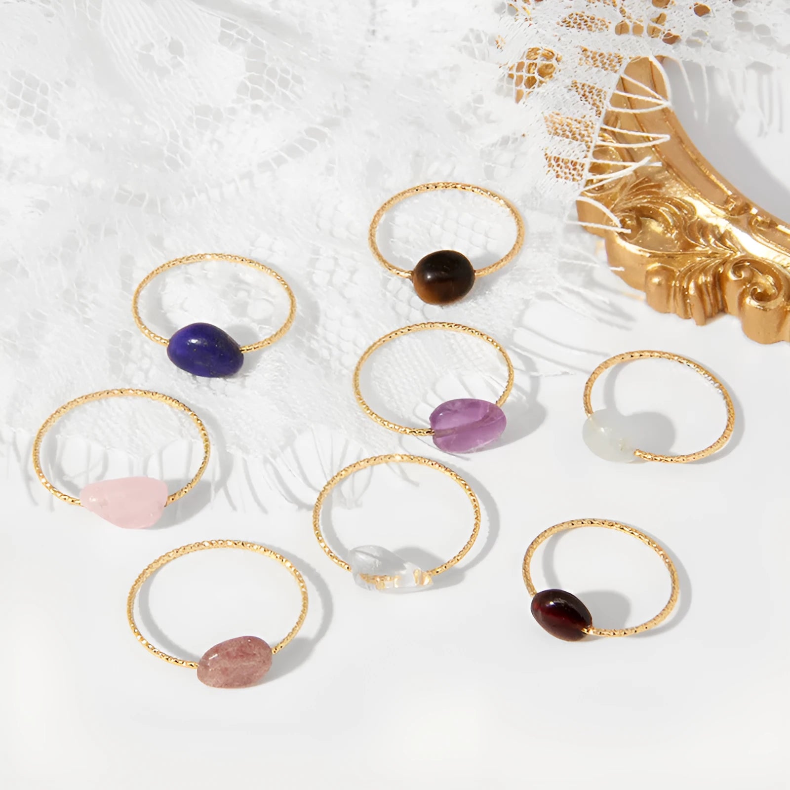 Geometric silver-toned ring setting with a central oval of blue and white banded agate stone on a woman's hand.