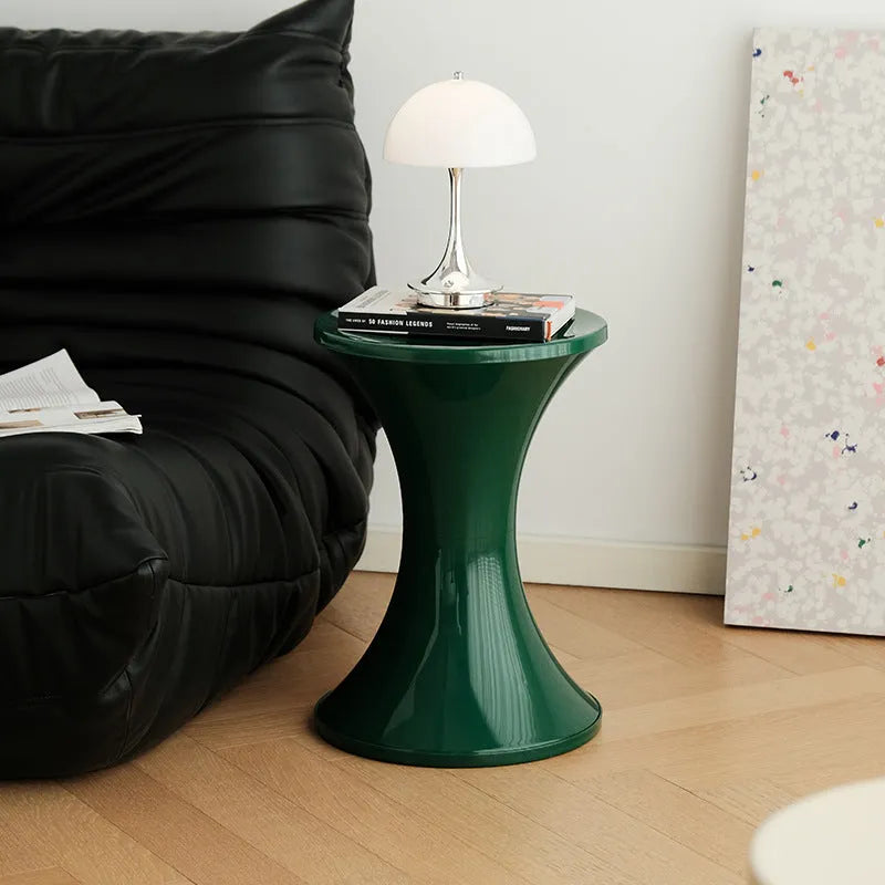 Hourglass-shaped plastic shoe changing stool in a choice of five colours: black, green, red, white, brown.