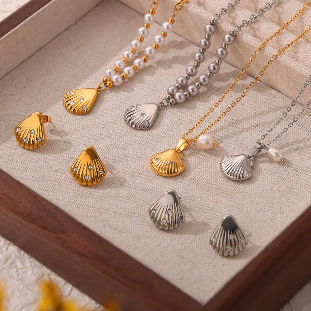 Gold-tone titanium steel necklace with white freshwater pearl beads on an O-shaped chain.