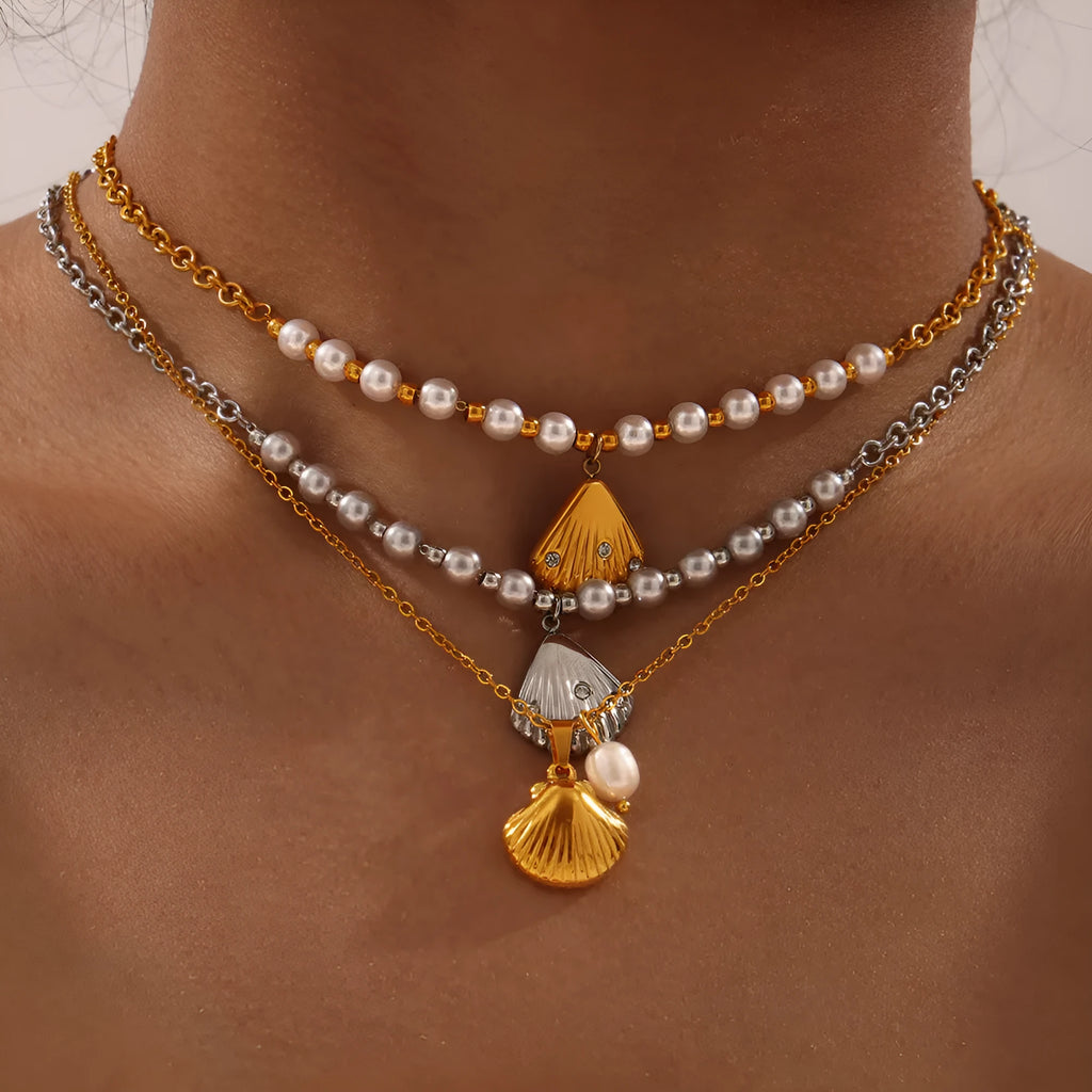 Gold-tone titanium steel necklace with white freshwater pearl beads on an O-shaped chain.