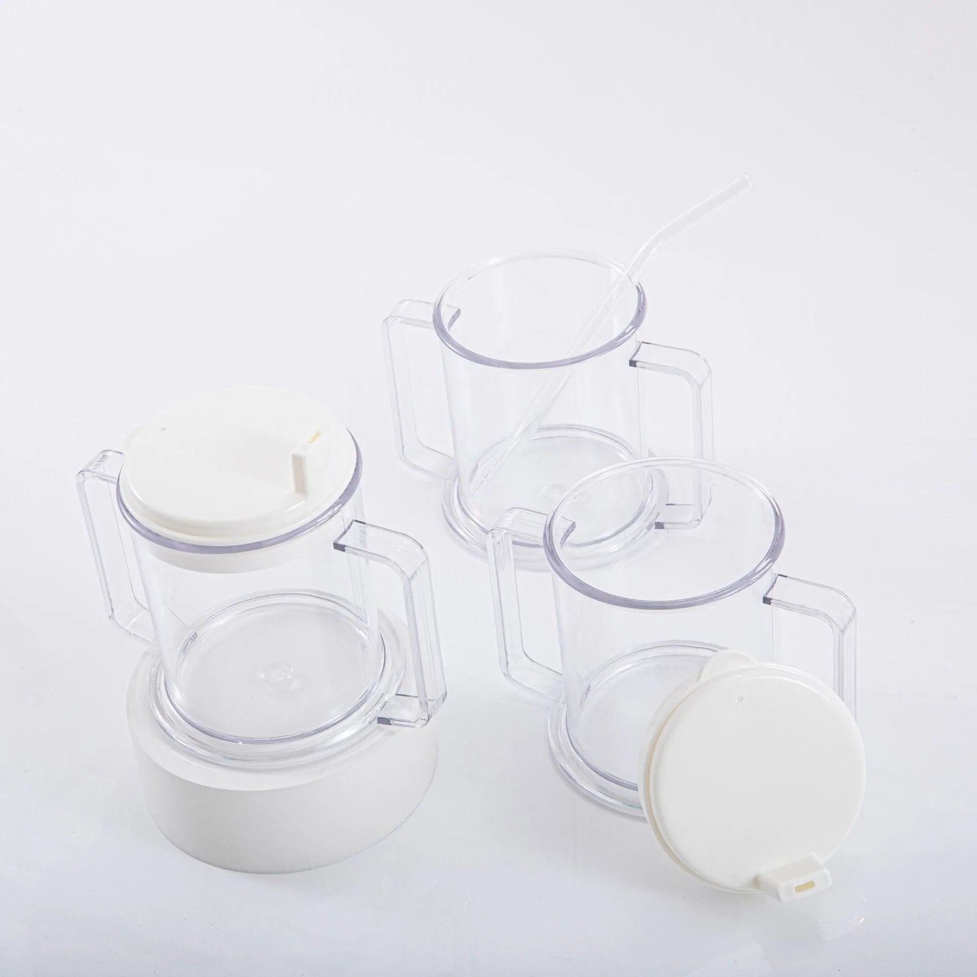 Transparent plastic drinking cup with a lid on a solid background.
