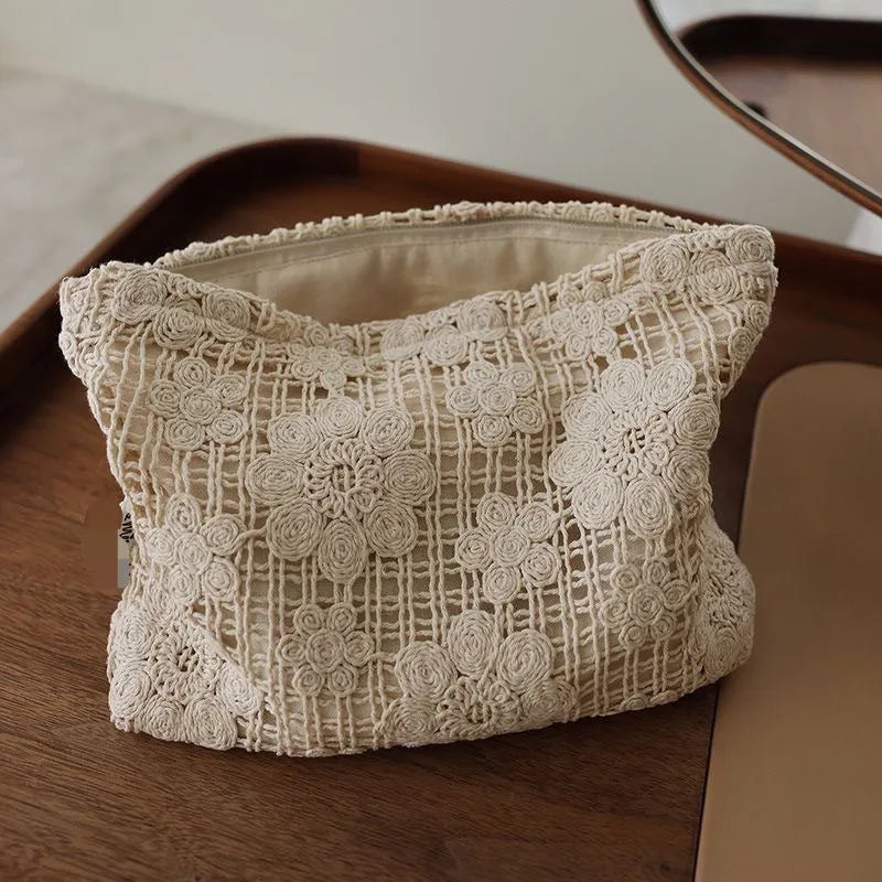 Handmade corduroy cosmetic bag with a crocheted hollow flower and ethnic embroidery design.