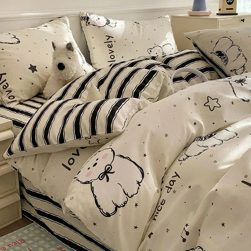 Cartoon dog pattern four-piece pure cotton bedding set laid on a dormitory bed.