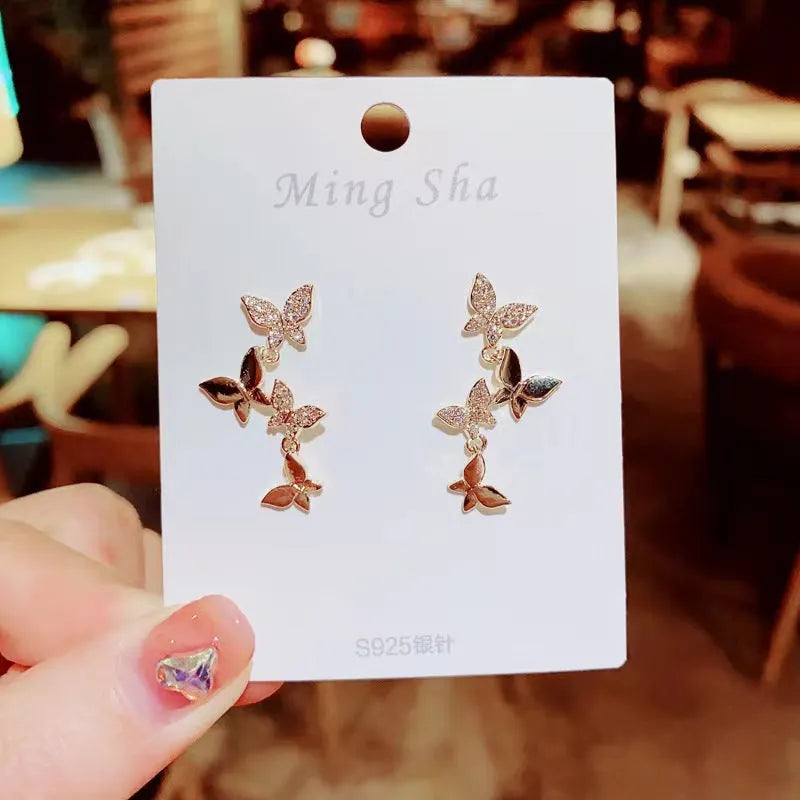 Women's copper butterfly drop earrings with gold-coloured four-butterfly design